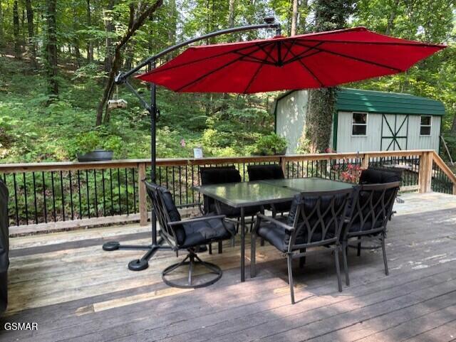928 E Cross Rd, Dandridge, TN 37725 - deck featuring outdoor dining space and a view of trees