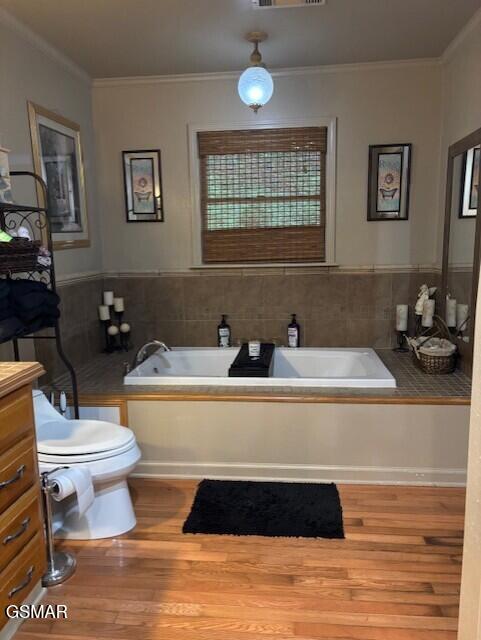 928 E Cross Rd, Dandridge, TN 37725 - full bath with a garden tub, toilet, crown molding, wood finished floors, and vanity