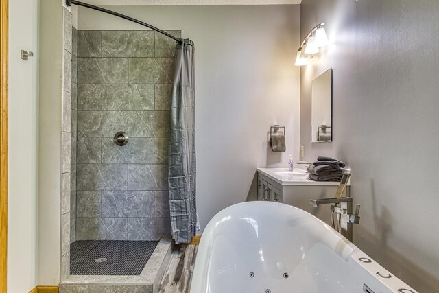 bathroom featuring shower with separate bathtub and vanity