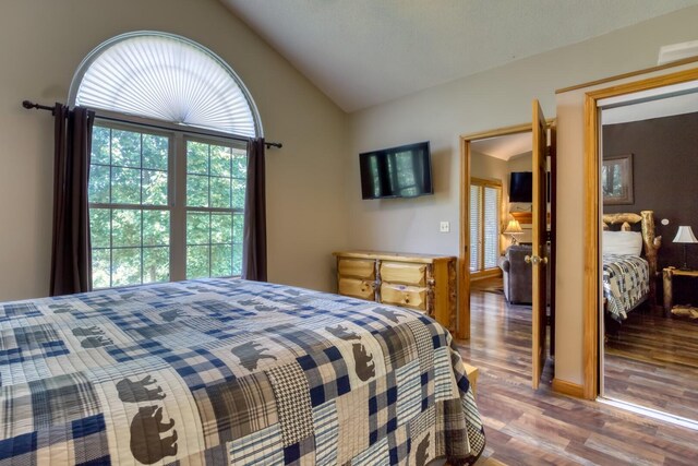 bedroom featuring hardwood / wood-style floors and vaulted ceiling