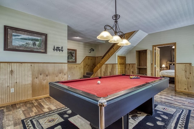 game room with dark hardwood / wood-style floors, billiards, vaulted ceiling, a textured ceiling, and wooden walls