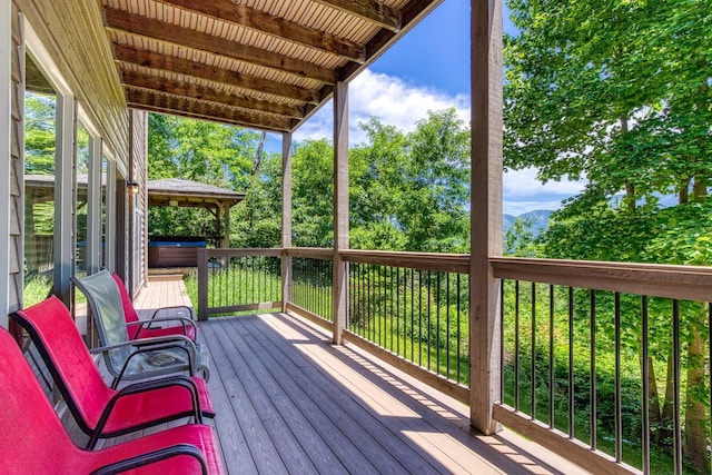 wooden deck with a hot tub