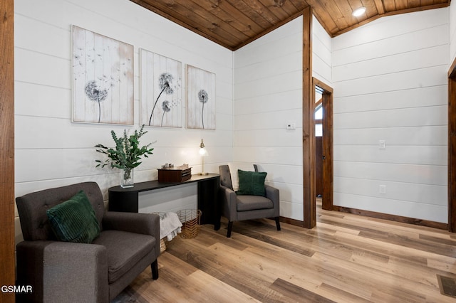 living area featuring baseboards, visible vents, wooden ceiling, vaulted ceiling, and light wood-style floors