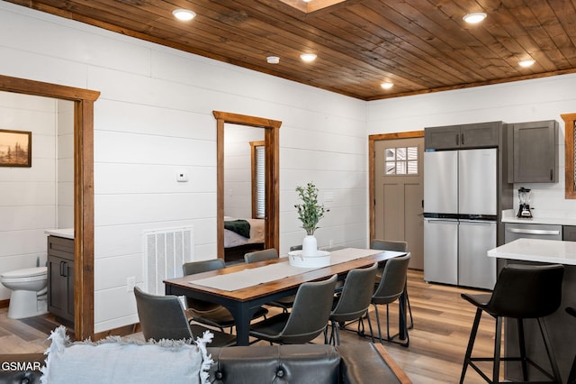 dining space with wooden ceiling, light wood-style flooring, visible vents, and recessed lighting