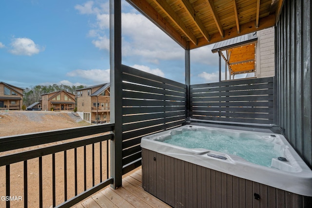 wooden deck with a hot tub