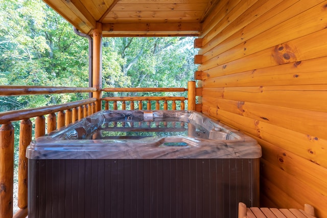 wooden deck with a hot tub