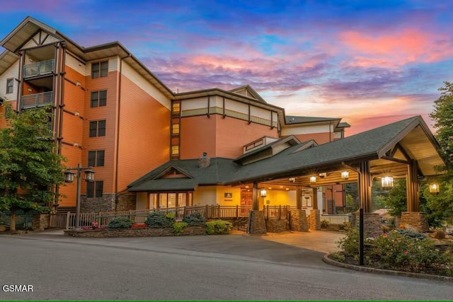 view of outdoor building at dusk