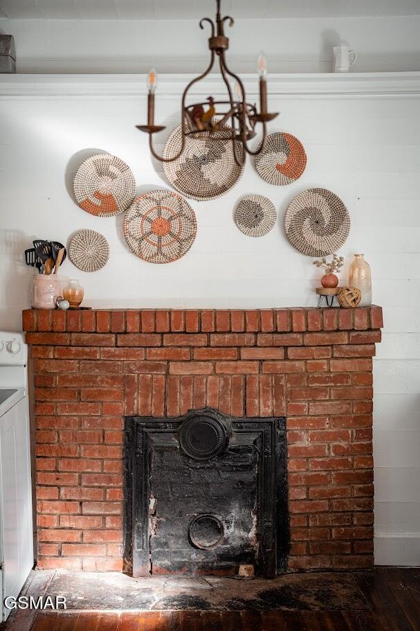 room details featuring a fireplace, washer / dryer, and white range