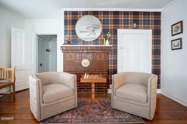sitting room with wood-type flooring and crown molding
