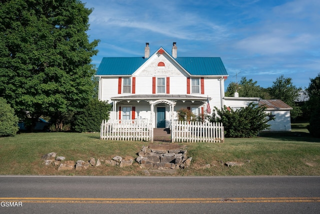 view of front of home with a porch and a front lawn