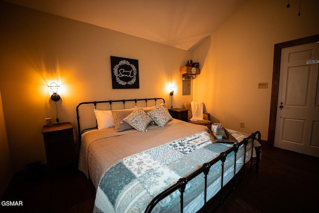 bedroom featuring lofted ceiling and electric panel