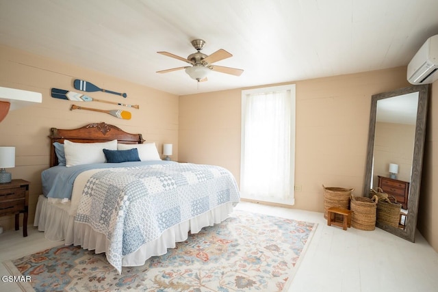 bedroom with a wall unit AC and ceiling fan