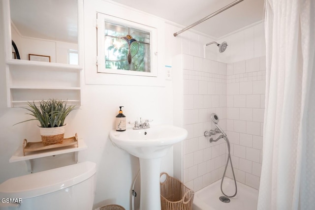bathroom featuring toilet and walk in shower