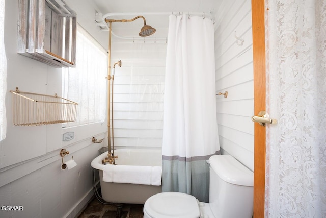 bathroom with toilet and shower / bathtub combination with curtain