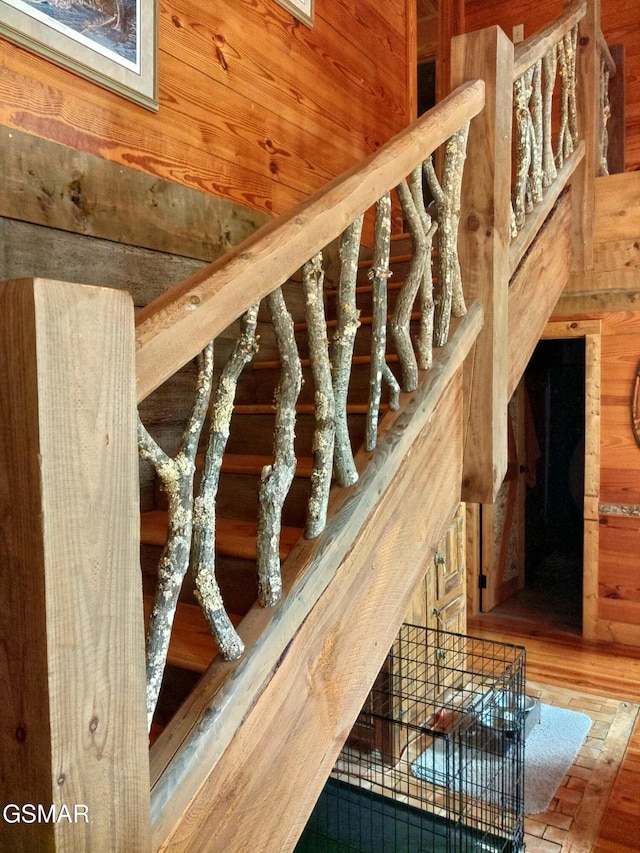 3644 Wears Mountain Ln, Sevierville, TN 37862 - staircase with wooden walls and wood finished floors