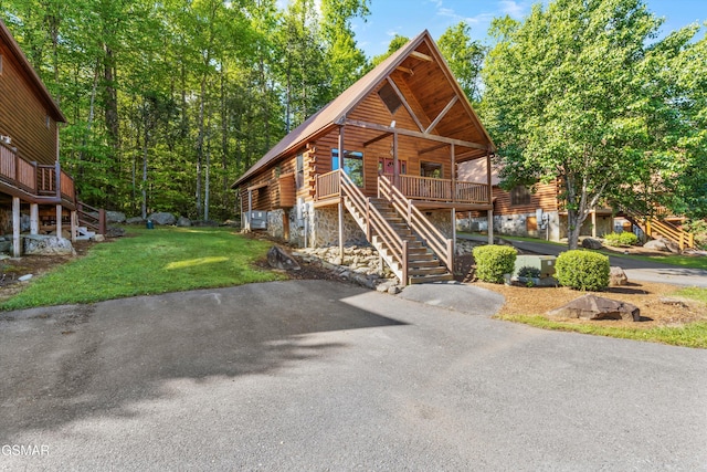 212 Forrest Loop Way, Gatlinburg, TN 37738 - log-style house with stairs, a front lawn, and log exterior