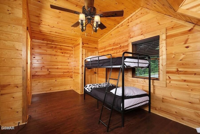 bedroom with lofted ceiling, wood walls, wooden ceiling, and dark wood finished floors