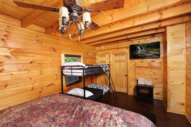 bedroom with wooden ceiling, wooden walls, dark wood-style flooring, and beamed ceiling