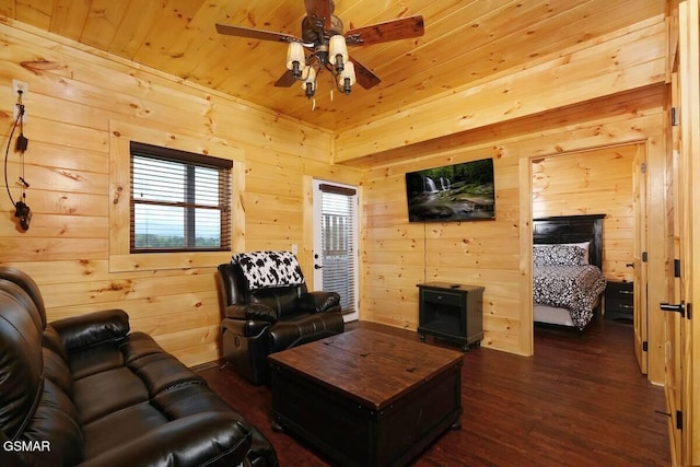 living area featuring wood walls, dark wood-style flooring, wood ceiling, and a ceiling fan