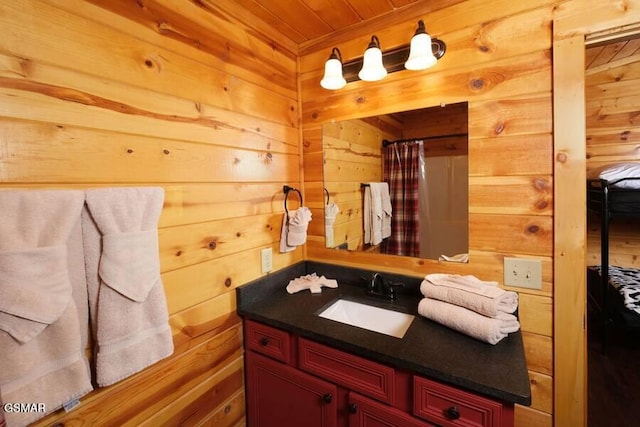 full bath featuring wooden ceiling, wooden walls, a shower with curtain, and vanity