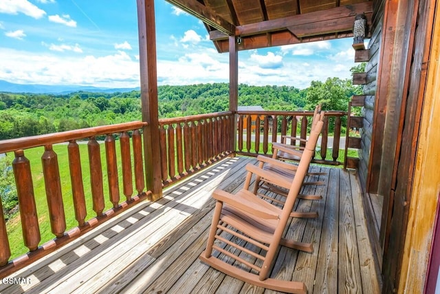 wooden terrace with a view of trees