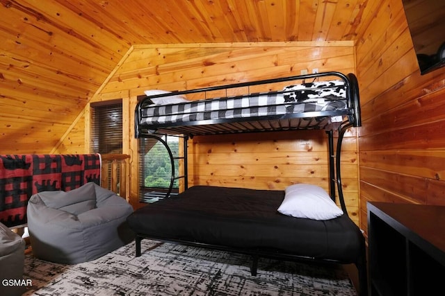 bedroom featuring lofted ceiling, wood walls, and wood ceiling