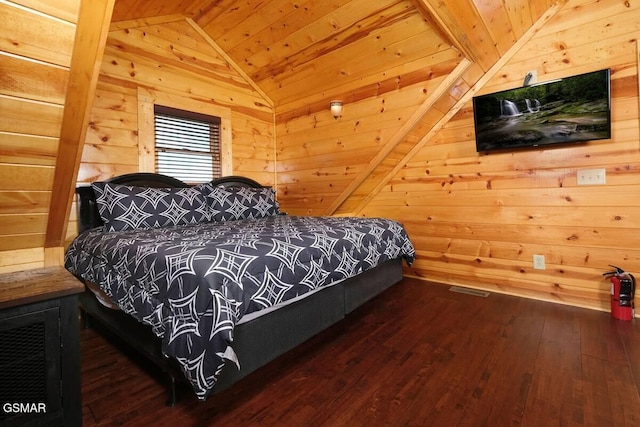 bedroom featuring wood walls, wood ceiling, vaulted ceiling, and hardwood / wood-style flooring