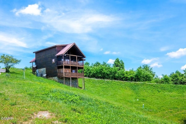 rear view of house featuring a wooden deck