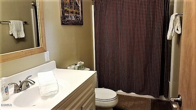 bathroom with vanity, toilet, and walk in shower