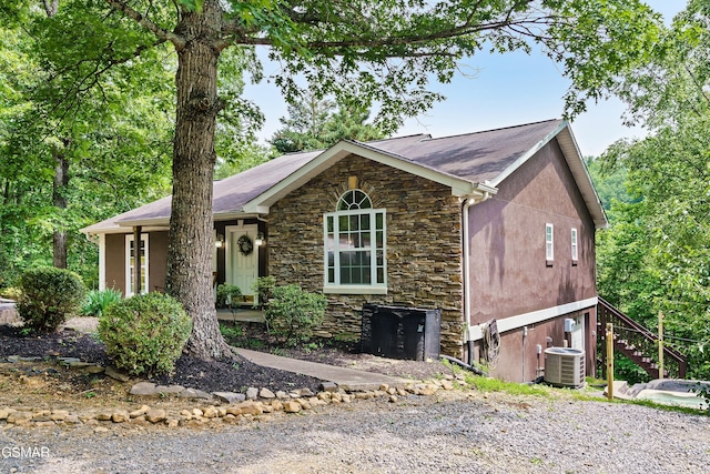 3230 Cove Creek Way, Sevierville, TN 37862 - ranch-style house with stone siding, central AC unit, stucco siding, and stairs