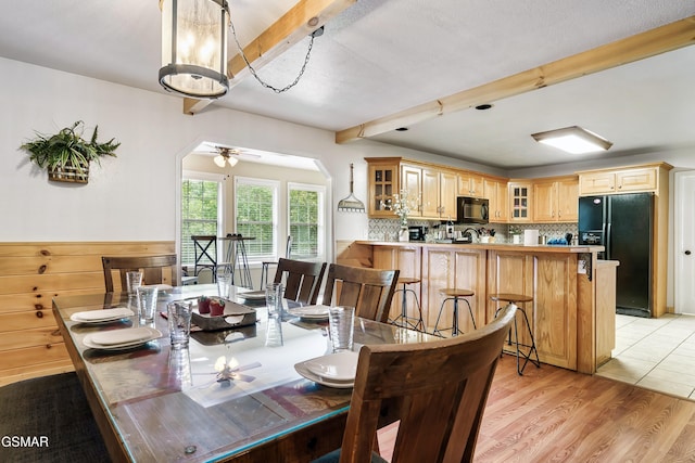 3230 Cove Creek Way, Sevierville, TN 37862 - dining area featuring beamed ceiling, arched walkways, a ceiling fan, and light wood-type flooring