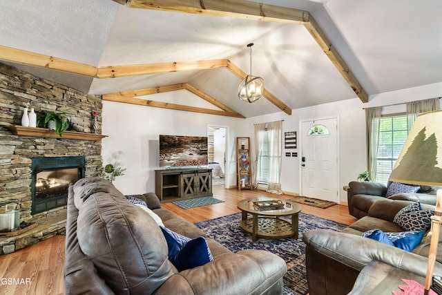 3230 Cove Creek Way, Sevierville, TN 37862 - living room with wood finished floors, a stone fireplace, and a chandelier