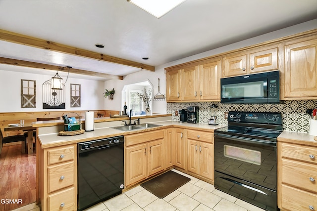 3230 Cove Creek Way, Sevierville, TN 37862 - kitchen with black appliances, a sink, a peninsula, light countertops, and beam ceiling