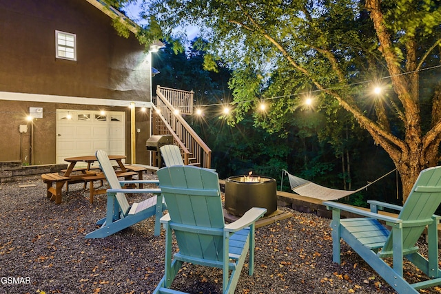 3230 Cove Creek Way, Sevierville, TN 37862 - yard at twilight with a fire pit, stairs, and a garage
