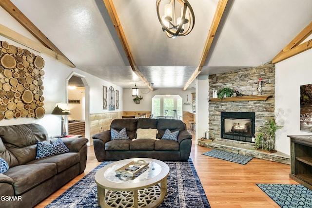 3230 Cove Creek Way, Sevierville, TN 37862 - living area featuring wood finished floors, arched walkways, a stone fireplace, and wainscoting