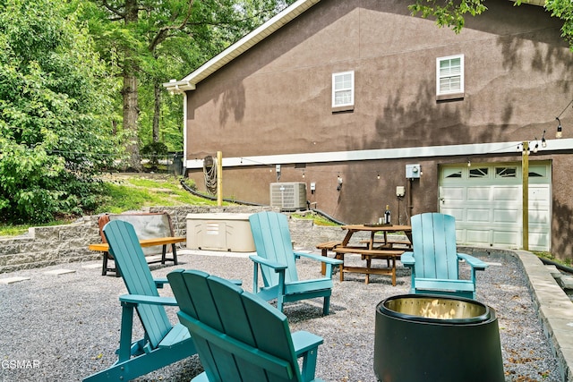 3230 Cove Creek Way, Sevierville, TN 37862 - view of patio / terrace featuring an outdoor fire pit, central AC, and a garage