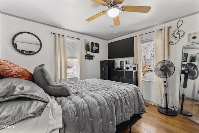 bedroom with a ceiling fan and wood finished floors