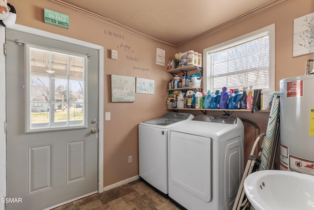 washroom featuring baseboards, laundry area, separate washer and dryer, crown molding, and gas water heater