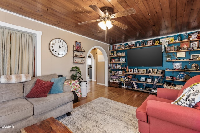 living area featuring arched walkways, wood ceiling, wood finished floors, and a ceiling fan