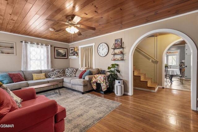 living area featuring plenty of natural light, wood ceiling, arched walkways, and wood-type flooring