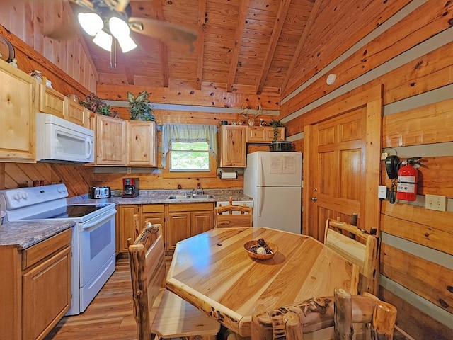 kitchen with white appliances, lofted ceiling with beams, wooden ceiling, and wood walls