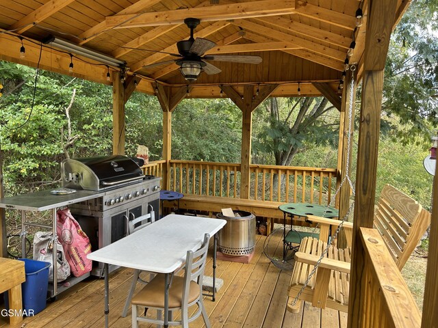 wooden deck with a gazebo and ceiling fan