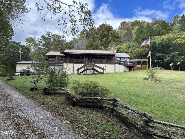 exterior space with a lawn and a wooden deck