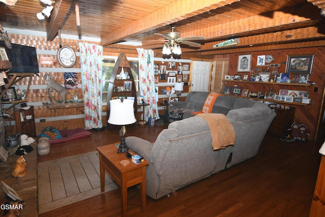 living room with ceiling fan, wooden ceiling, beamed ceiling, wooden walls, and hardwood / wood-style flooring