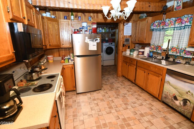 kitchen with washer / clothes dryer, sink, stainless steel appliances, and an inviting chandelier