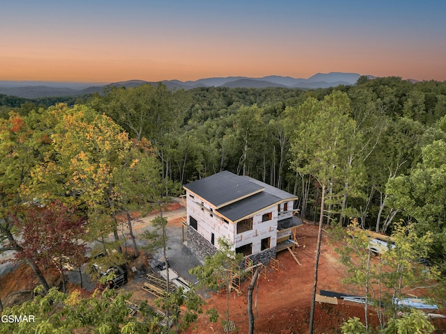 aerial view at dusk featuring a mountain view