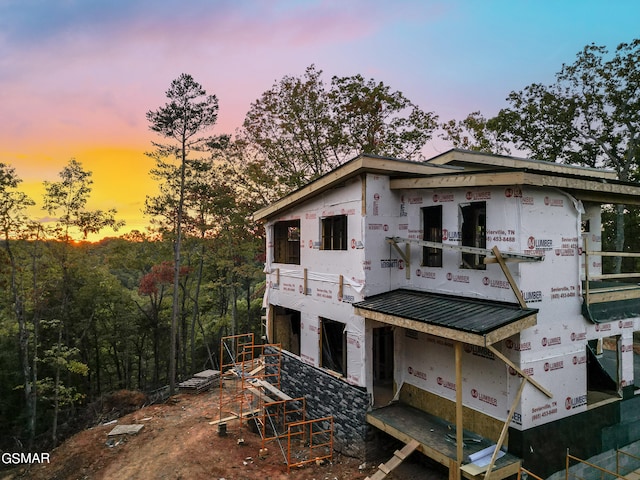 view of back house at dusk