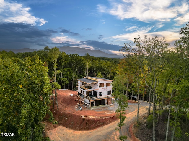 back house at dusk with a mountain view