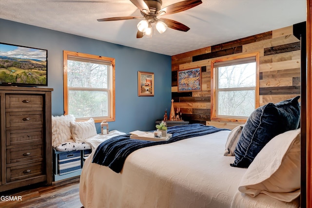 1001 Sunrise Blvd, Sevierville, TN 37862 - bedroom with a textured ceiling, wooden walls, a ceiling fan, and wood finished floors