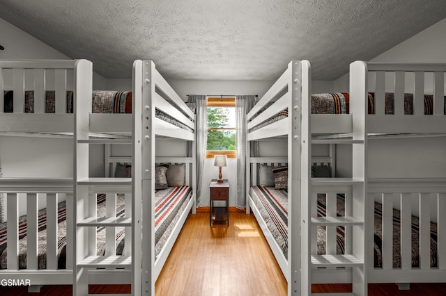 bedroom featuring hardwood / wood-style floors and a textured ceiling